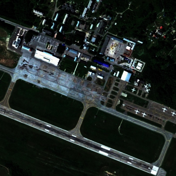 Original low-light satellite image of the same airport